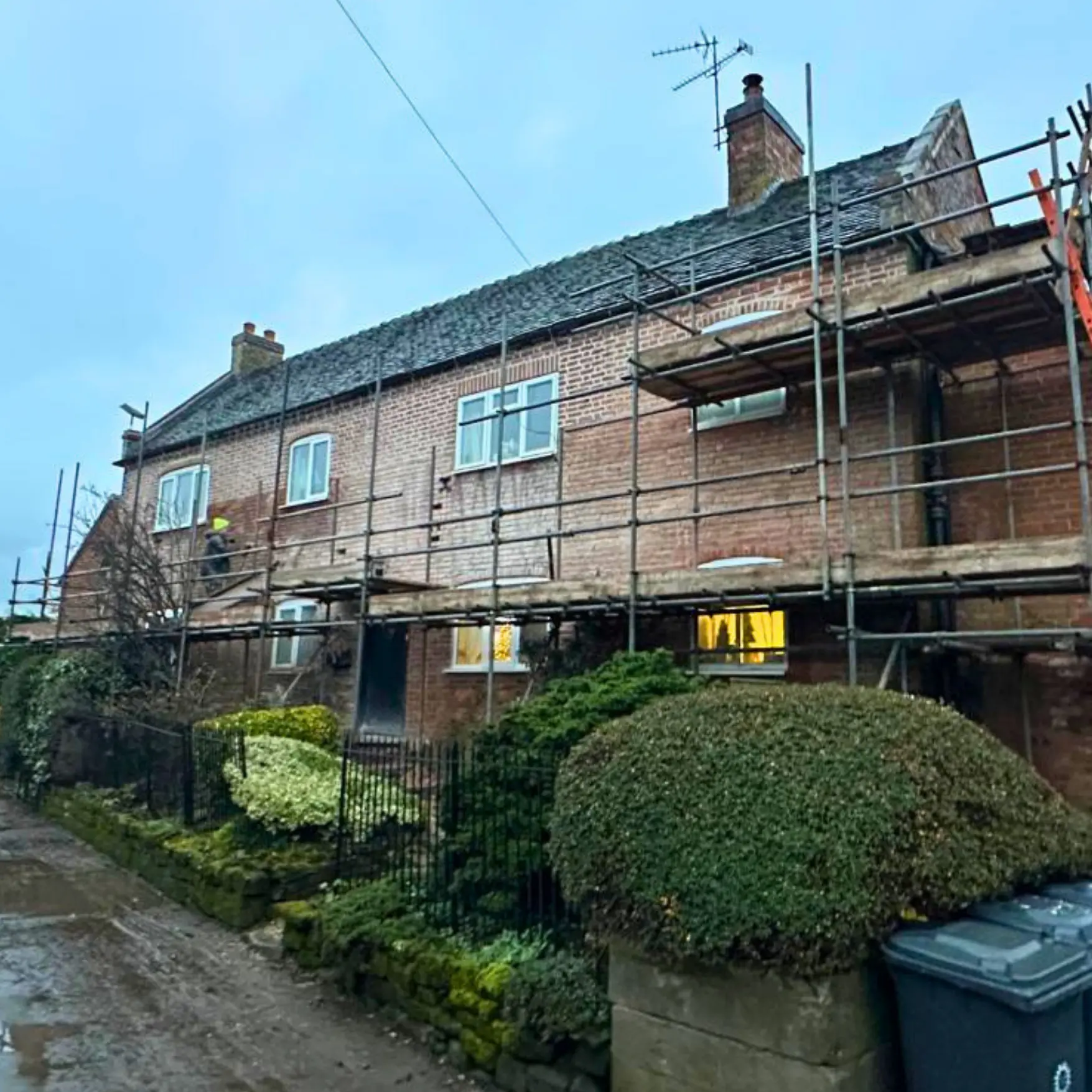 Period brick farmhouse under scaffolding during repointing and porch work, Lapley near Penkridge