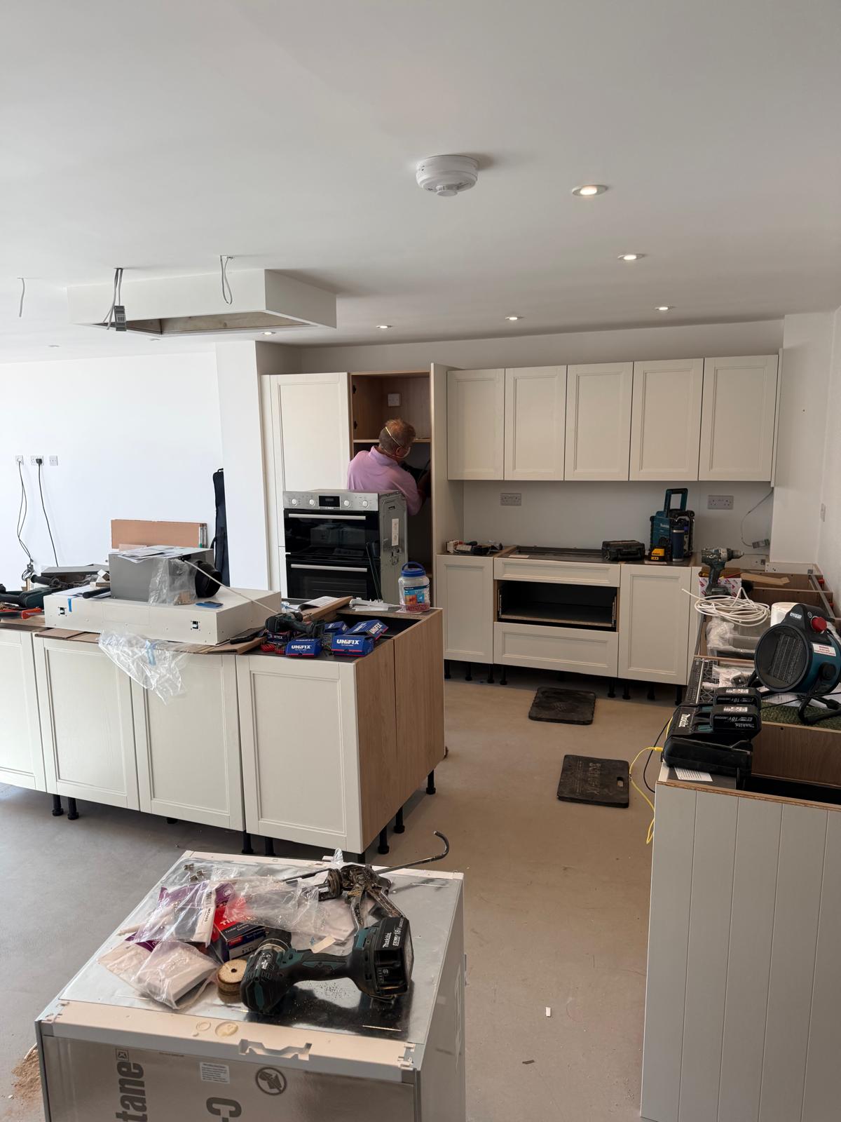 Large open-plan kitchen extension in Penkridge with shaker cabinetry being fitted